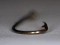 Picture of a standard fishing hook showing the "twist in the bend"  Picture of a standard fishing hook showing the "twist in the bend"
